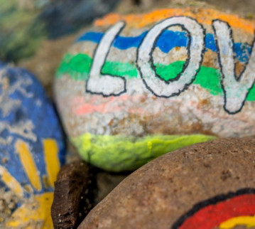 Stones on a beach with paintings on them