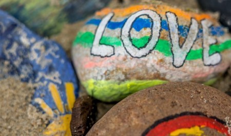 Stones on a beach with paintings on them