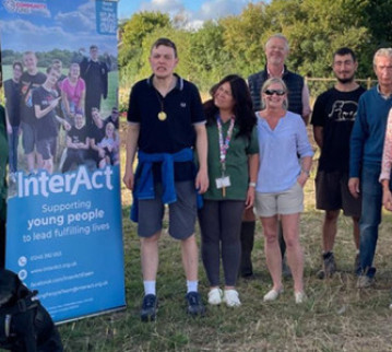 A group photo of the Interact team and children